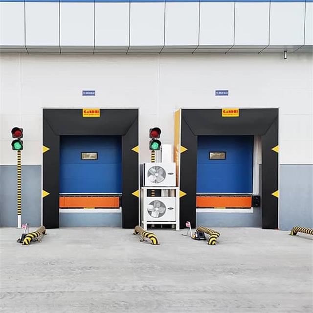 Loading dock shelter with dock seals and traffic light system for safe and efficient truck loading operations.